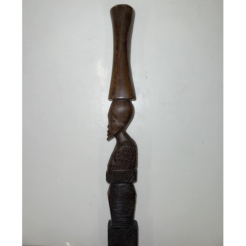 1115 - An African carved hardwood walking stick. Length 92cm