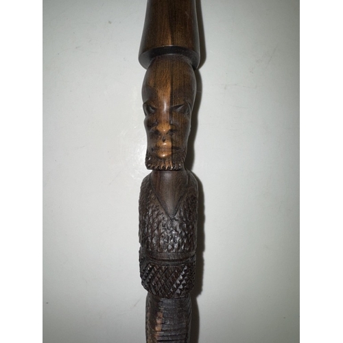 1115 - An African carved hardwood walking stick. Length 92cm