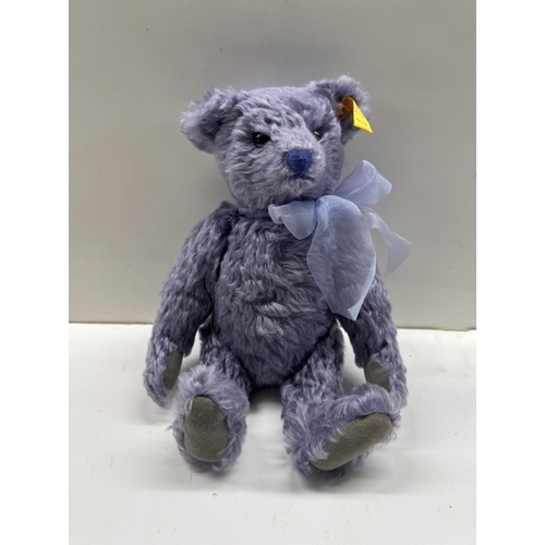 1184 - A Steiff lavender bear in rocking chair. (In Steiff bag)