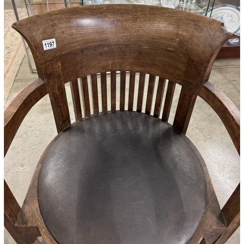 1197 - A Frank Lloyd Wright style barrel chair. Manufacturer flaw to back top right