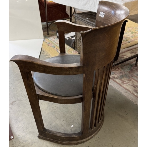 1197 - A Frank Lloyd Wright style barrel chair. Manufacturer flaw to back top right