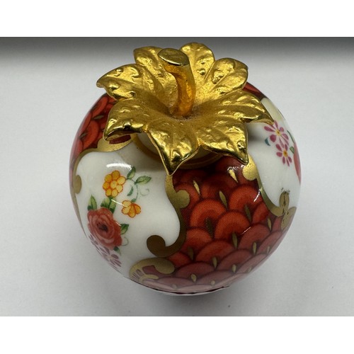 1160A - A Royal Worcester strawberry candle snuffer