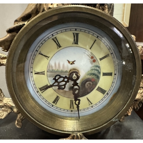 1545 - A 19th century gilt mantel clock surmounted figure with painted porcelain panels.