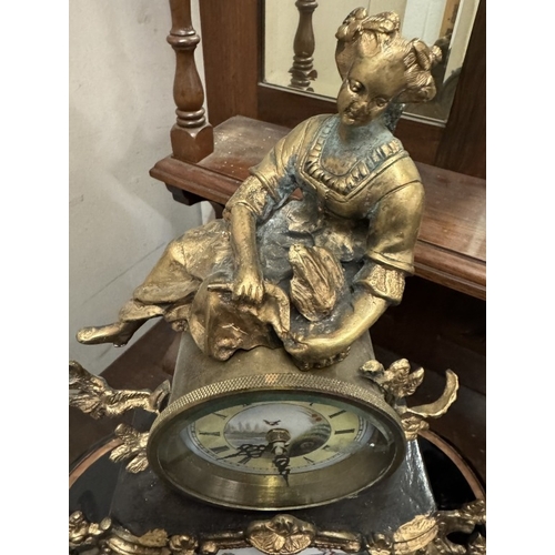 1545 - A 19th century gilt mantel clock surmounted figure with painted porcelain panels.