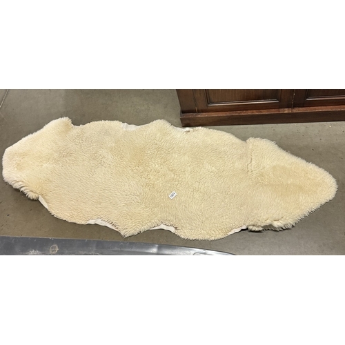 1571 - A long sheepskin rug (2 skins stitched together) 188cm