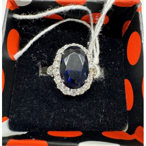 1100C - A Tanzanite CZ set in silver (0.925 marked) 1 stone missing.