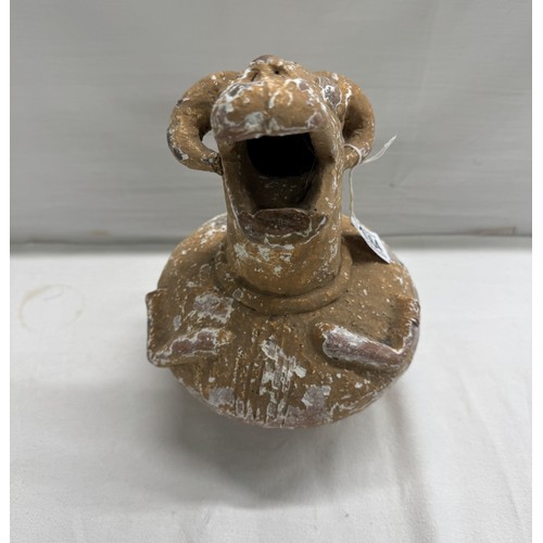 1564 - An antique terracotta jug with goats head spout.