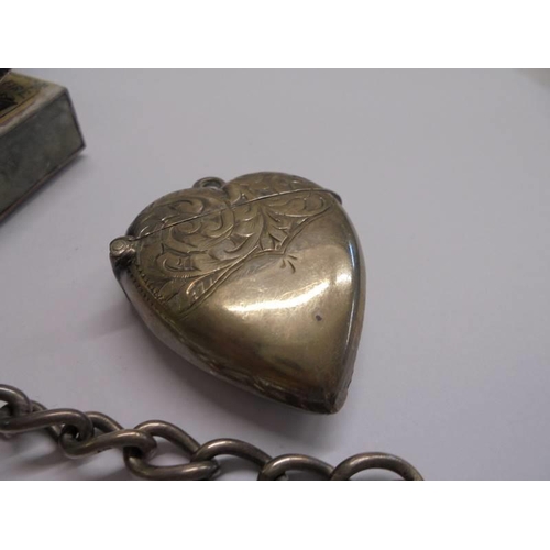 1023 - A silver watch chain, a silver heart shaped vesta case and a silver match box holder,