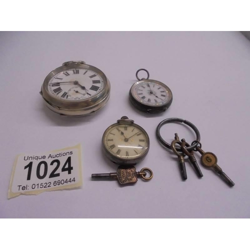 1024 - An old pocket watch, two silver fob watches and watch keys.