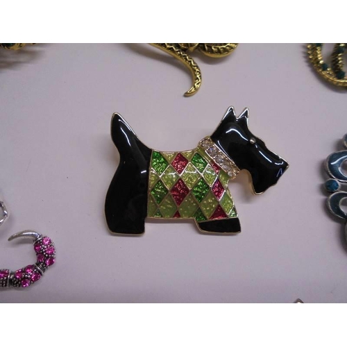 1027 - Eight good quality fashion brooches including peacock, snakes, dog etc.,