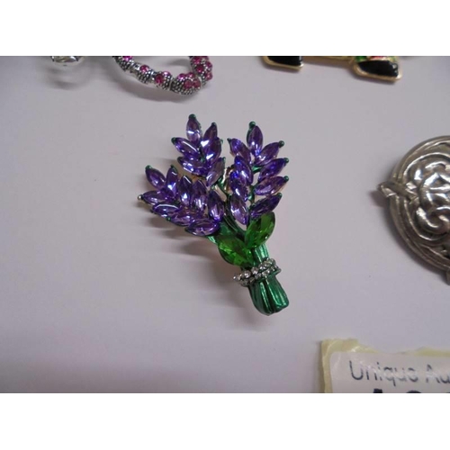 1027 - Eight good quality fashion brooches including peacock, snakes, dog etc.,