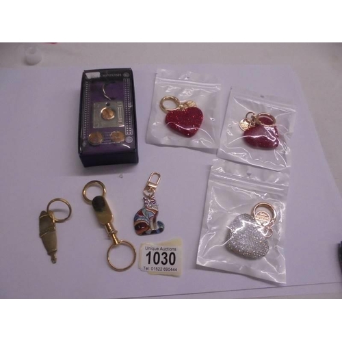 1030 - A boxed Macintosh style key ring with matching cuff links and six other key rings.