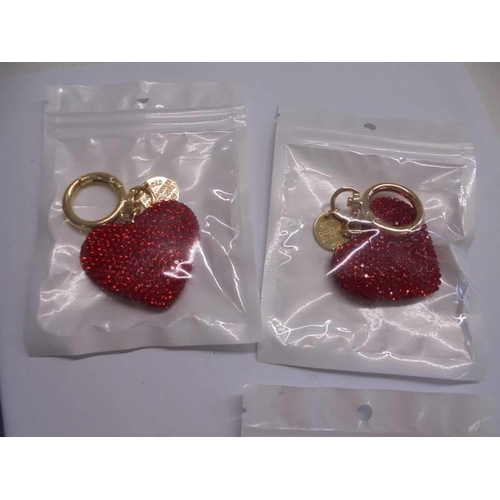 1030 - A boxed Macintosh style key ring with matching cuff links and six other key rings.