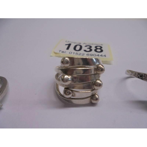 1038 - Four assorted silver dress rings.