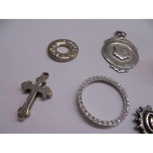 1042 - A silver fob, silver polo mint, silver cross, silver ball pendant and four other items.