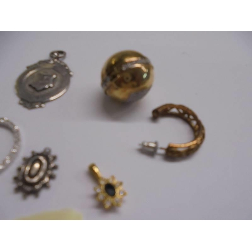 1042 - A silver fob, silver polo mint, silver cross, silver ball pendant and four other items.