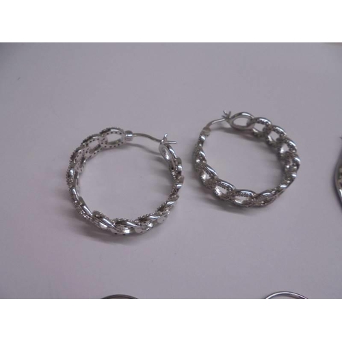 1047 - Ten pairs of white metal fashion earrings.