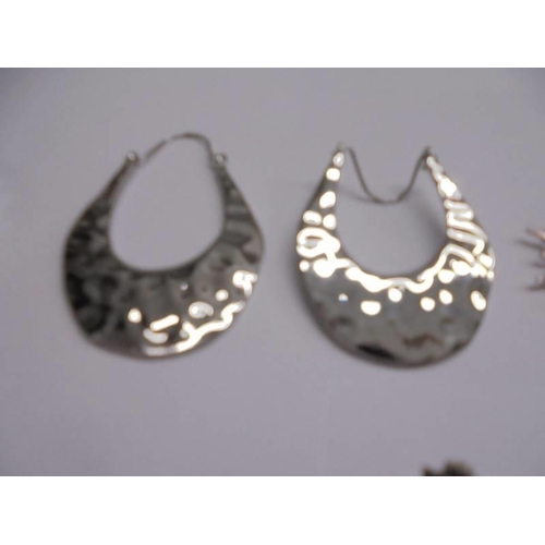 1047 - Ten pairs of white metal fashion earrings.