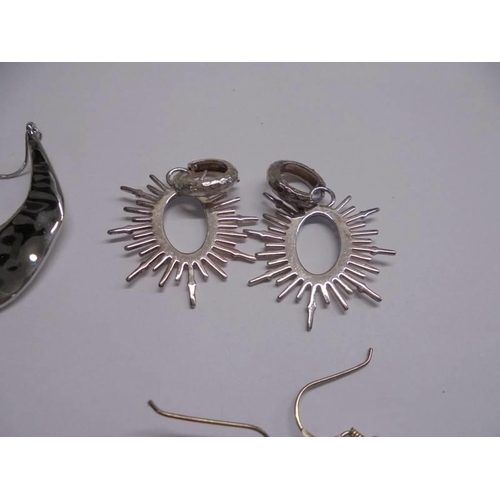 1047 - Ten pairs of white metal fashion earrings.