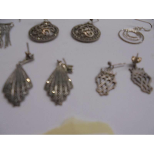 1047 - Ten pairs of white metal fashion earrings.