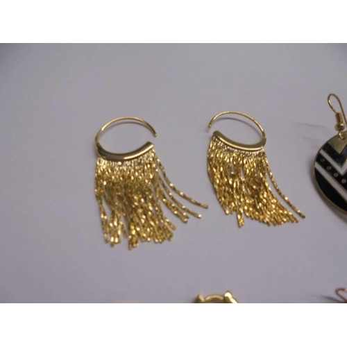 1048 - Six pair of yellow metal fashion earrings.