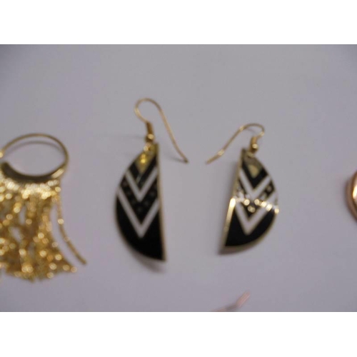 1048 - Six pair of yellow metal fashion earrings.