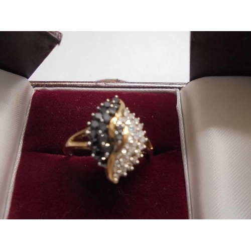 1051 - An exquisite 18ct gold ring set black and white diamonds, size S, 3.22 grams.