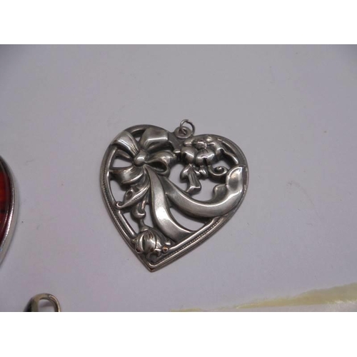 1054 - A silver art nouveau style pendant and two others.