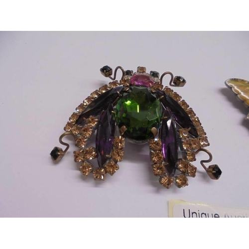 1055 - Two stone set insect fashion brooches.