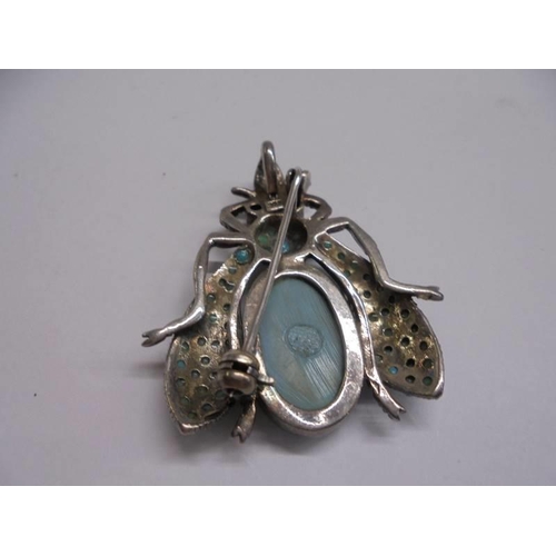 1056 - A silver turquoise set insect brooch.