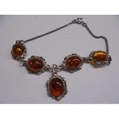 1063 - A silver and amber bracelet.