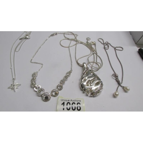 1068 - Three assorted white metal fashion pendants and a necklace.