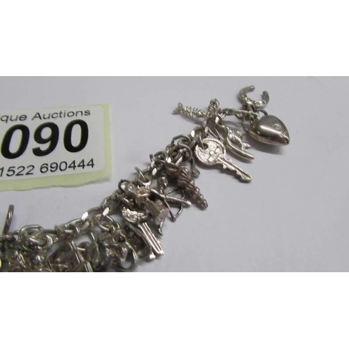 1090 - A silver (925) charm bracelet, most charms marked 925.