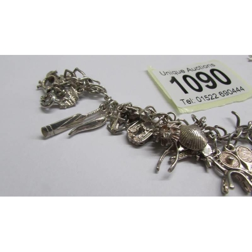 1090 - A silver (925) charm bracelet, most charms marked 925.