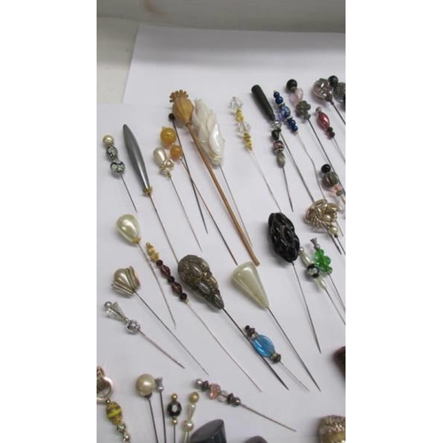 1095 - A good lot of vintage hat pins in all shapes and sized.