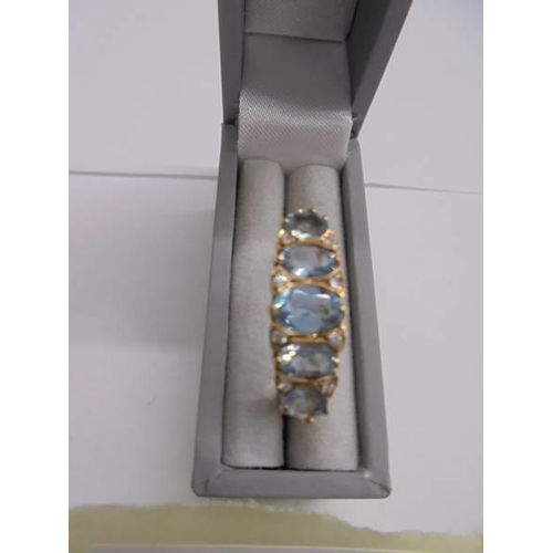 1134 - A diamond & blue topaz five stone ring in 9ct gold, London hall mark, sisze J, 2.23 grams.