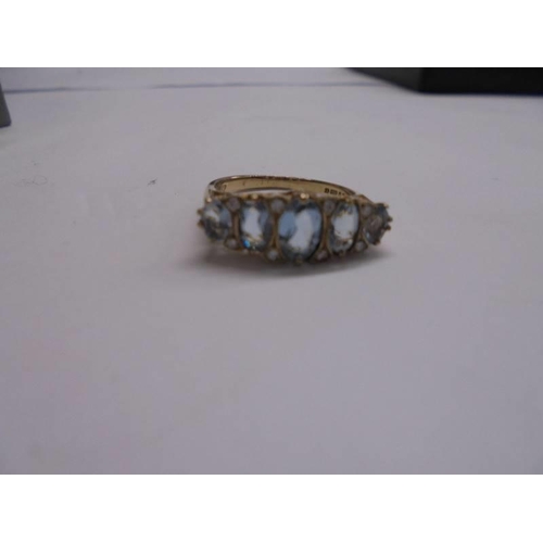 1134 - A diamond & blue topaz five stone ring in 9ct gold, London hall mark, sisze J, 2.23 grams.