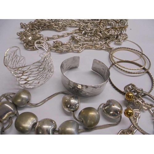 1141 - A quantity of assorted white metal chains, bangles etc.,