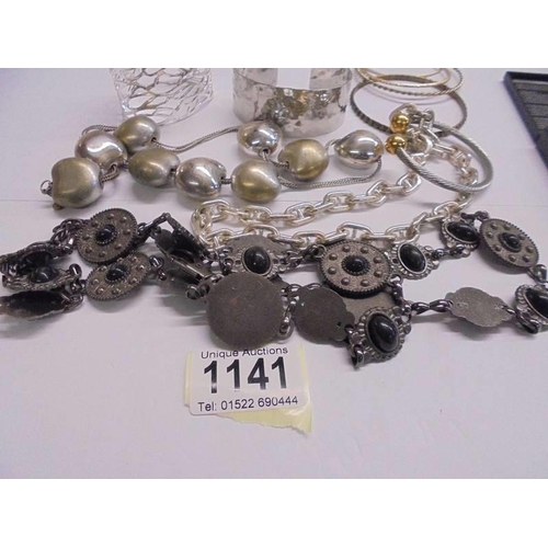 1141 - A quantity of assorted white metal chains, bangles etc.,