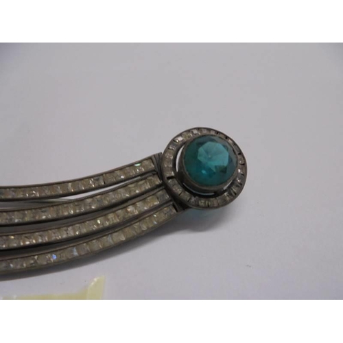 1146 - An art deco silver brooch set white and green stones.