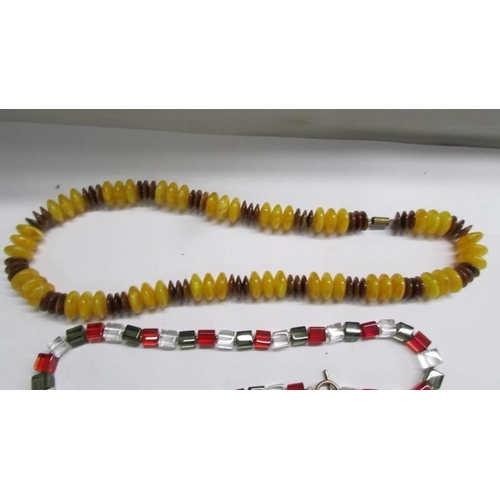 1152 - Four good bead necklaces and a pair of yellow metal earrings.