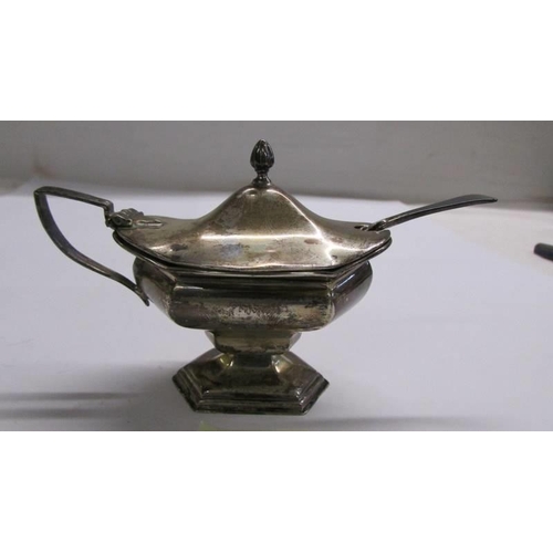 1170 - A silver mustard pot with a white metal spoon.