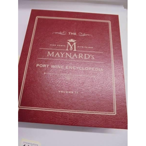 1180 - A boxed bottle of Pol Rogers champagne and a Maynards Port encyclopaedia.