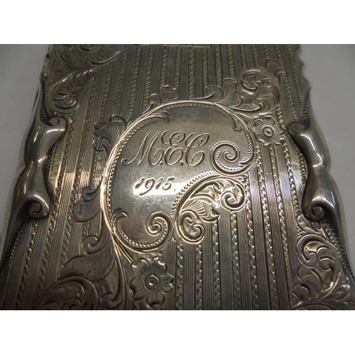 1190 - A ornate silver monogrammed Walker & Hall card case complete with pencil, dated 1915.