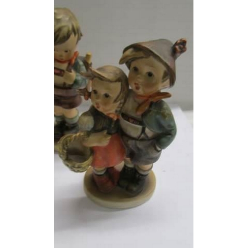 1232 - Five assorted Hummel child figures.