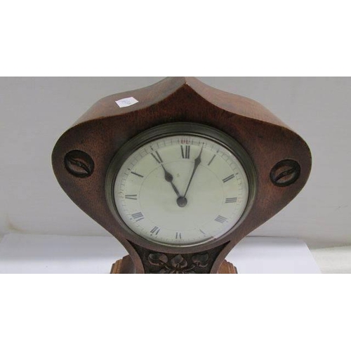 1234 - An art nouveau oak mantel clock.