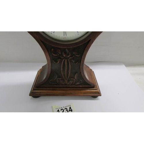 1234 - An art nouveau oak mantel clock.