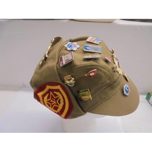 1281 - A Russian cap with various badge attached.