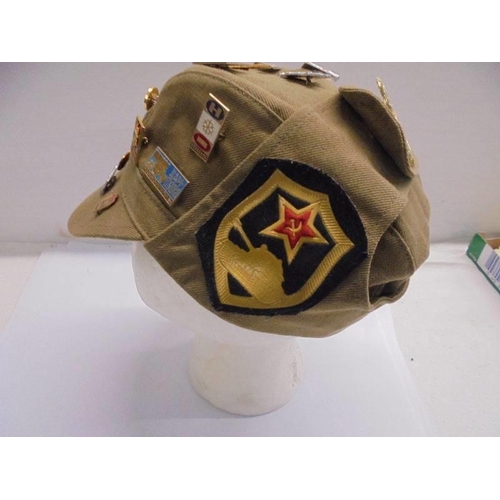 1281 - A Russian cap with various badge attached.