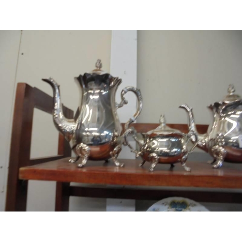 1289 - A four piece silver plate tea set with cone finials.